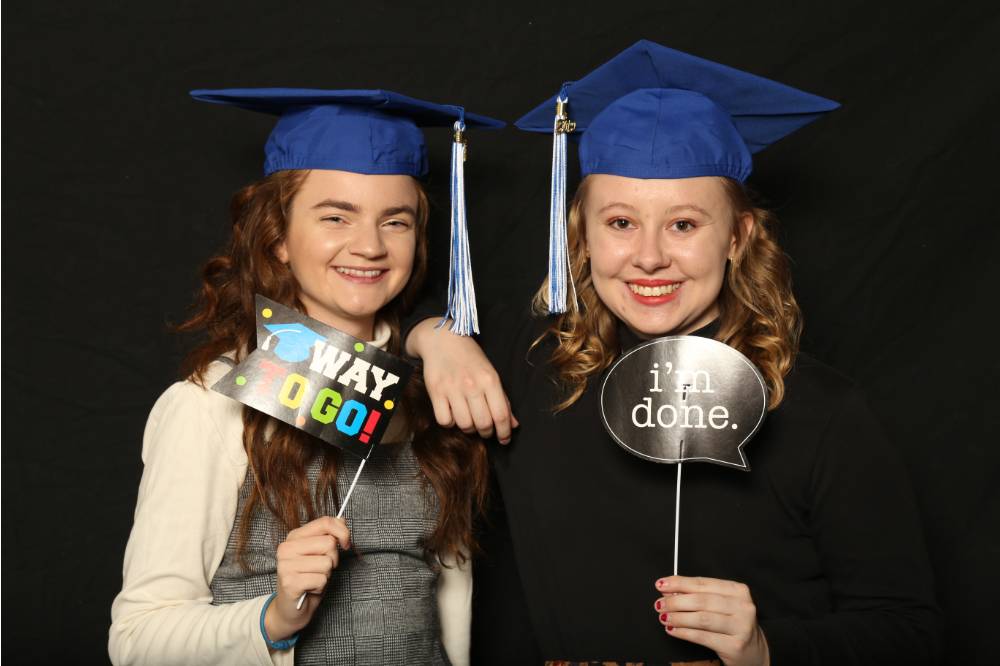 two lakers with props at gradfest 2019 photo booth